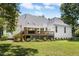 Well-maintained rear exterior with a spacious deck, lovely landscaping, and a lush green lawn at 904 Parkridge Dr, Clayton, NC 27527