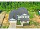 An aerial view showcases the well-maintained two-story home with a two car garage and beautiful landscaping at 93 Kinsale Ct, Garner, NC 27529