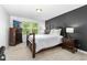 Cozy bedroom featuring a dark wood bed frame, matching dresser and nightstand, and a bright window at 93 Kinsale Ct, Garner, NC 27529