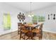 Cozy dining area with a wood table and chairs, a decorative light fixture, and large windows at 93 Kinsale Ct, Garner, NC 27529