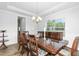 Dining room featuring a large table with seating for eight, a chandelier, and natural light at 93 Kinsale Ct, Garner, NC 27529