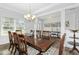 Elegant dining room with natural light, a large table, and stylish decor at 93 Kinsale Ct, Garner, NC 27529