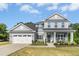 Beautiful two-story home featuring a covered front porch, attached garage, and well-maintained landscaping at 93 Kinsale Ct, Garner, NC 27529