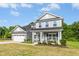 Charming two-story home with a landscaped yard, a front porch with seating, and a two-car garage at 93 Kinsale Ct, Garner, NC 27529