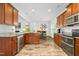 Spacious kitchen featuring wooden cabinets, stainless steel appliances, and a view into the dining area at 93 Kinsale Ct, Garner, NC 27529