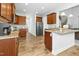 Well-equipped kitchen with dark wood cabinets, granite countertops, and stainless steel appliances at 93 Kinsale Ct, Garner, NC 27529
