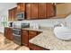 Kitchen with stainless steel appliances, granite counters, and wood cabinets at 93 Kinsale Ct, Garner, NC 27529