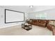 Entertainment room featuring a projection screen, comfortable seating, and stylish decor at 93 Kinsale Ct, Garner, NC 27529
