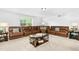 Spacious living room with a plush leather sectional, accent tables, and a coffee table at 93 Kinsale Ct, Garner, NC 27529