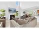 Bright living room features a fireplace, a television, and large windows offering plenty of natural light at 93 Kinsale Ct, Garner, NC 27529