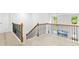 Second floor landing with wood and iron railing showcasing lots of light at 93 Kinsale Ct, Garner, NC 27529