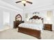 Spacious main bedroom features dark wood furniture, carpet flooring and a large bright window at 93 Kinsale Ct, Garner, NC 27529