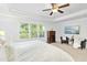 Bright and spacious main bedroom with verdant view, tray ceiling and accent chairs at 93 Kinsale Ct, Garner, NC 27529