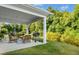 Covered patio with outdoor seating and a grill, perfect for entertaining and enjoying the backyard at 93 Kinsale Ct, Garner, NC 27529
