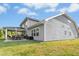 A lovely view of this two-story home, showcasing the covered patio with seating and spacious yard at 93 Kinsale Ct, Garner, NC 27529