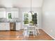 Cozy dining area with wood laminate flooring and views of the backyard at 1008 Alderleaf Dr, Fuquay Varina, NC 27526