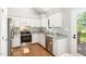Bright kitchen features granite counters, stainless steel appliances, and wood laminate flooring at 1008 Alderleaf Dr, Fuquay Varina, NC 27526