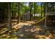 Backyard featuring playground set, shed, and surrounding trees at 102 Bluegrass Dr, Oxford, NC 27565