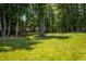 Wide open backyard with shady trees and play area at 102 Bluegrass Dr, Oxford, NC 27565