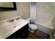 A bathroom featuring a vanity with a sink, wood flooring, a toilet, and a tub with a shower at 102 Bluegrass Dr, Oxford, NC 27565