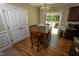 Dining area features a wooden table with chairs, a sliding glass door, and laminate flooring at 102 Bluegrass Dr, Oxford, NC 27565