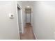 Hallway with neutral walls and carpet, offering access to different areas of the home at 102 Bluegrass Dr, Oxford, NC 27565