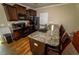Kitchen featuring wooden cabinets, granite countertops, a breakfast bar, and modern appliances at 102 Bluegrass Dr, Oxford, NC 27565