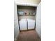 Laundry closet featuring a washer and dryer, shelving with laundry supplies, and bifold doors at 102 Bluegrass Dr, Oxford, NC 27565