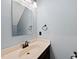 Charming powder room featuring a pedestal sink, bronze fixtures, and soft blue walls for a serene space at 1030 W Sterlington Pl, Apex, NC 27502