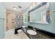 Bright bathroom with a shower-tub combo, a granite-topped vanity, and soft, blue painted walls at 1030 W Sterlington Pl, Apex, NC 27502