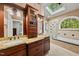 Well-appointed bathroom with dual vanities, a glass-enclosed shower, and a soaking tub for spa-like relaxation at 1030 W Sterlington Pl, Apex, NC 27502