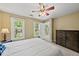 Bedroom with natural light, white bedspread, and a dark dresser for storage at 1030 W Sterlington Pl, Apex, NC 27502