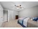 Bedroom with neutral walls, ceiling fan, and a small wooden bookshelf for storage or decor at 1030 W Sterlington Pl, Apex, NC 27502