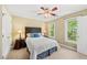 Bright bedroom with two windows for natural light, a ceiling fan, and carpeted flooring at 1030 W Sterlington Pl, Apex, NC 27502