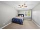 Cozy bedroom features a ceiling fan, neutral walls, and a bright window with natural light at 1030 W Sterlington Pl, Apex, NC 27502