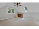 Open bonus room with carpet, bright window, ceiling fan and wet bar for modern comfort at 1030 W Sterlington Pl, Apex, NC 27502
