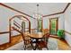 Bright dining room with wood trim, a round table, and archway to the foyer at 1030 W Sterlington Pl, Apex, NC 27502