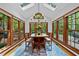 Dining room with many windows and a view of the lush surrounding landscape at 1030 W Sterlington Pl, Apex, NC 27502