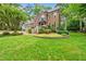 Beautiful brick home with lush front lawn and landscaped flower bed at 1030 W Sterlington Pl, Apex, NC 27502
