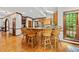 Kitchen with wood cabinets, stainless steel appliances, breakfast bar, with a breakfast area in the background at 1030 W Sterlington Pl, Apex, NC 27502