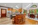 Spacious eat-in kitchen with natural wood cabinets, skylights, and an adjoining dining space at 1030 W Sterlington Pl, Apex, NC 27502