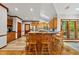 An eat-in kitchen featuring oak cabinets, updated stainless steel appliances, wood floors, and a breakfast bar at 1030 W Sterlington Pl, Apex, NC 27502