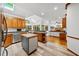 Open-concept kitchen with stainless steel appliances, a butcher block island, and a view of the living room at 1030 W Sterlington Pl, Apex, NC 27502