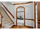 Cozy foyer with hardwood floors and stairway leading into a warm and inviting living room at 1030 W Sterlington Pl, Apex, NC 27502