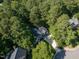Gray brick home surrounded by lush trees and green lawn at 104 Warley Cir, Cary, NC 27513