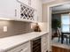Convenient butler pantry featuring a wine cooler and custom cabinetry at 104 Warley Cir, Cary, NC 27513