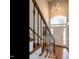 Elegant foyer with wooden stairs, chandelier, and a large arched window above the front door at 104 Warley Cir, Cary, NC 27513