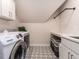 Efficient laundry room with modern appliances, ample counter space, and stylish patterned flooring at 104 Warley Cir, Cary, NC 27513