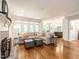 Open living room with fireplace, hardwood floors, and multiple windows for natural light at 104 Warley Cir, Cary, NC 27513
