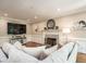 Cozy living room with fireplace, hardwood floors, and decorative wainscoting at 104 Warley Cir, Cary, NC 27513